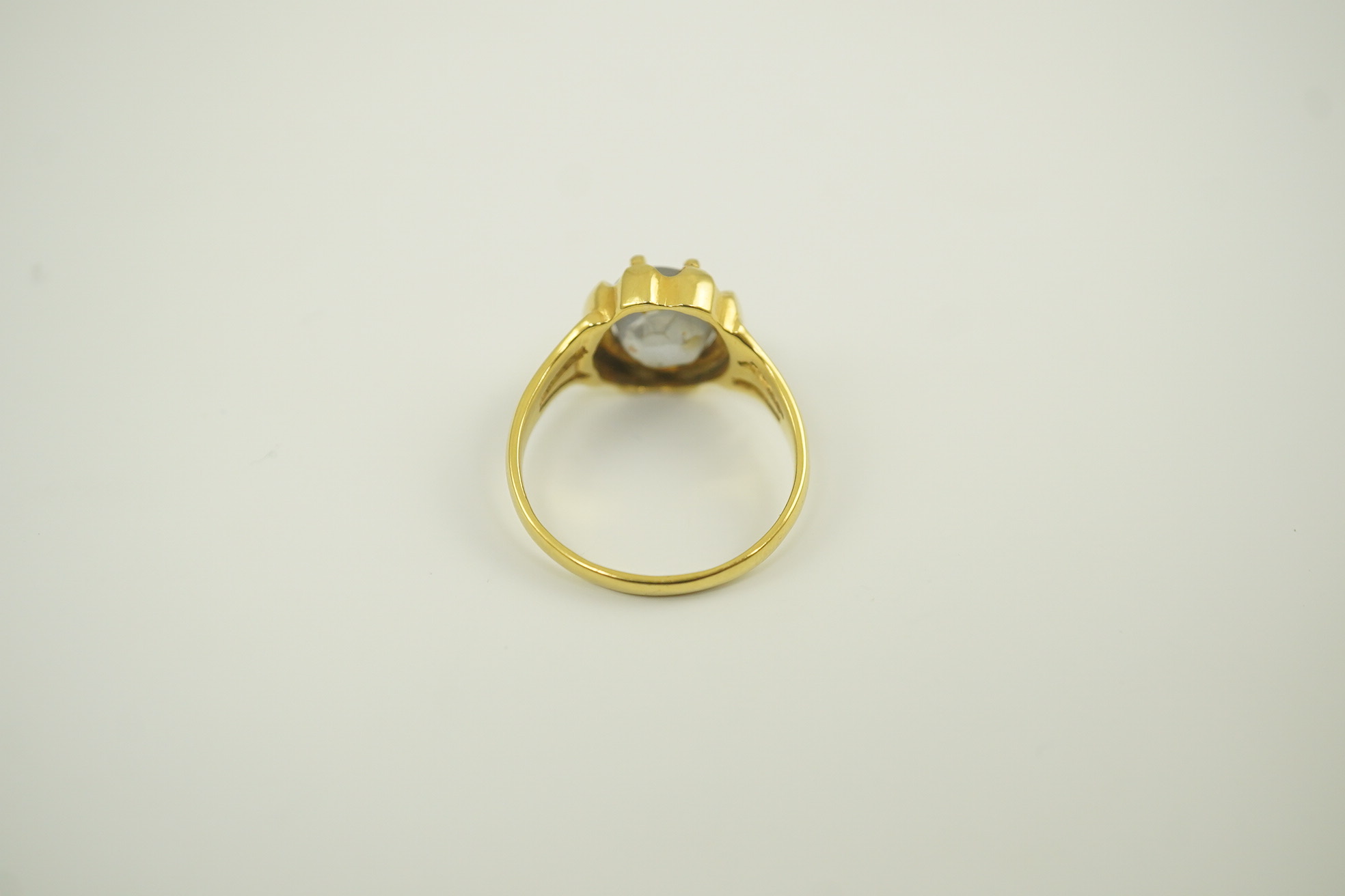 A modern 18k gold and single stone cabochon star sapphire set ring